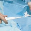 Surgeon manipulating a flexible catheter