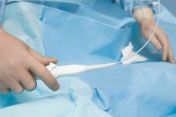 Surgeon manipulating a flexible catheter